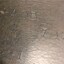 Piece of leather with letters and numbers stamped on it.
