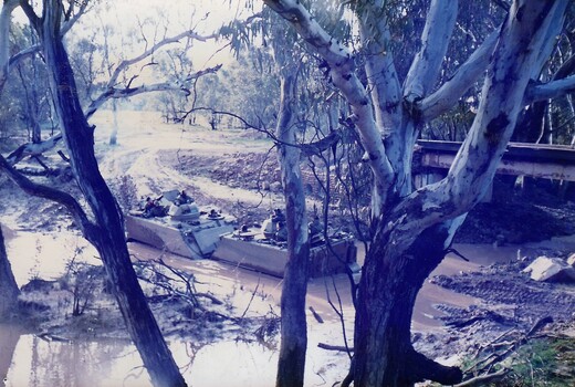 Tanks crossing a flooded creek.
