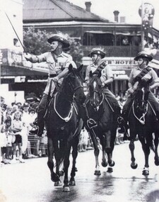 Three soldiers with swords on horses