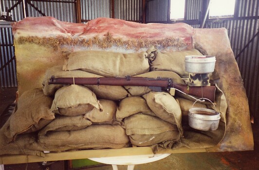 Rifle, sand bags and billies