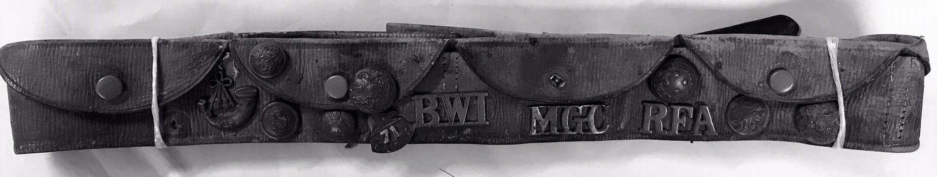 Leather belt with pockets and badges