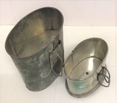 Two metal cups with folding handles