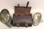 Two tin cups beside open leather case