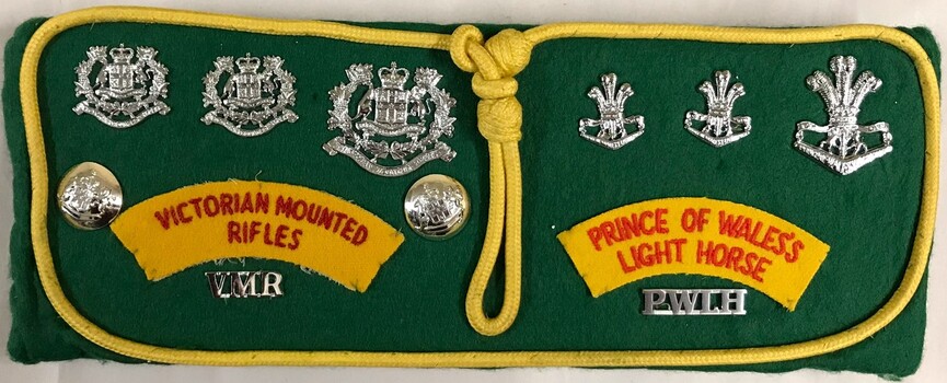 Badges, Buttons and Titles" Victorian Mounted Rifles and Prince of Wales Light Horse framed by a yellow lanyard.