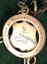 metal badge with engraving on it