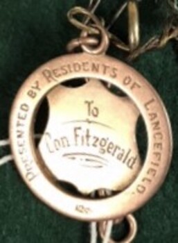 metal badge with engraving on it