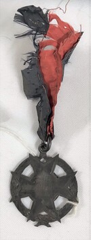 Maltese cross in a circle medallion with pattered ribbon attached