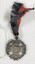 Maltese cross in a circle medallion with pattered ribbon attached