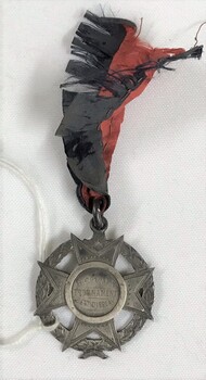 Maltese cross in a circle medallion with pattered ribbon attached