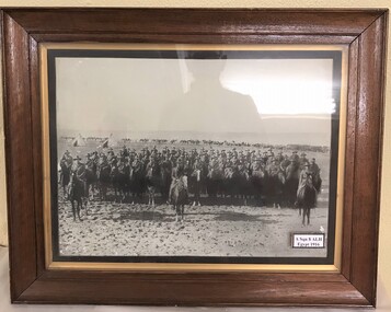 Photograph of soldiers and horses in a frame