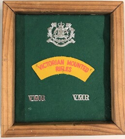 Framed board with badges and printed label