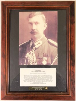 framed portrait of soldier with text on board.