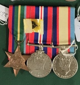 Three medals with coloured ribbons attached