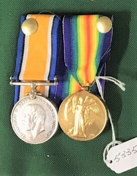 Two medals with coloured ribbons attached