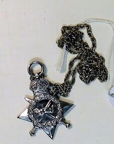 Star shaped medal attached to a chain