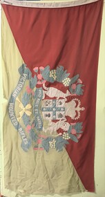 large coloured flag with crest at centre