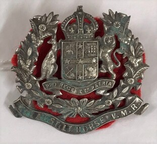 Metal badge with a cloth backing