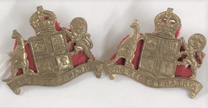 Two metal badges with cloth backing