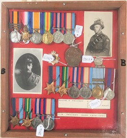 Framed board with medals and photographs