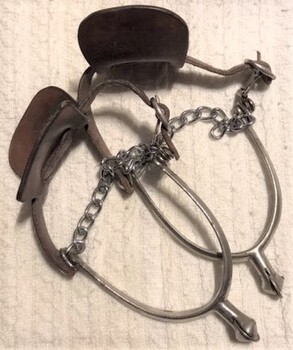Pair of spurs with leather straps and chains