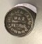 Small metal cylinder with printing on lid