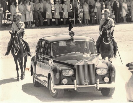 Two Lighthorsemen beside shiny car.