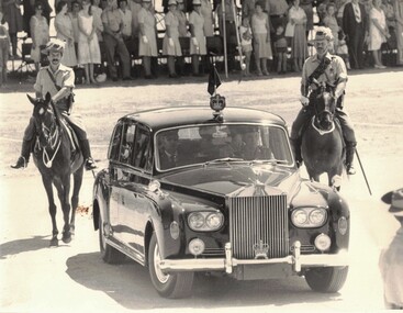 Two Lighthorsemen beside shiny car.