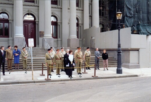 Group of people in formal dress standing in front of building