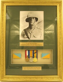 Photo and medals in frame