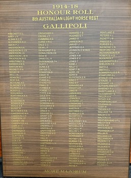 Stained board with names listed in four columns