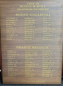 Stained rectangular board with titles and columns of names in gold lettering.