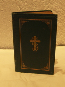 Hard cover book with embossed gold cross, text in German