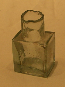 Small glass bottle, square in shape