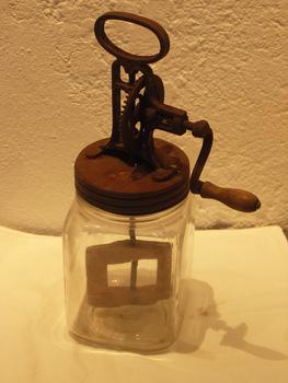 Hand-crank butter churn in glass jar