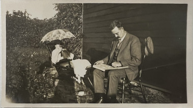 Photograph - Viewing an album in a garden