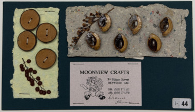 10 buttons on handmade paper on green card with dried flowers, 1995