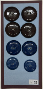 8 buttons on blue paper on red card, c. 1930