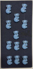 12 buttons on dark blue card, c. 1950s