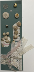 15 buttons and 6 swatches of trim on green card, 1930s