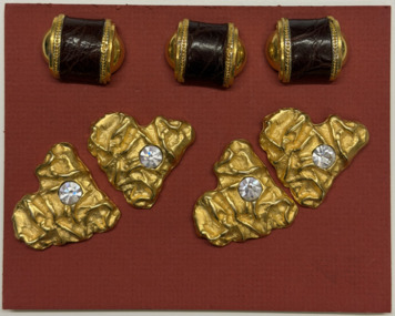 7 buttons on terracotta card with 4 split pins, Circa 2000
