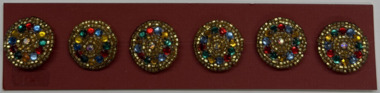 6 buttons on terracotta card, 1990's