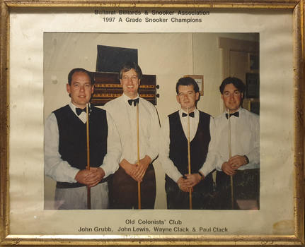 4 men holding billiard cues