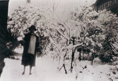 Photograph, Miss McPhee in Snow Laden Garden, c1920