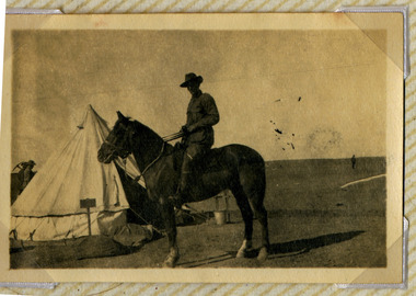 soldier posing on horse in camp, red cliffs 00108.tif