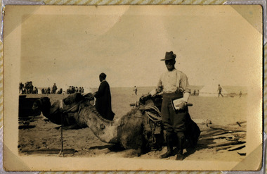 soldier posing with camel, red cliffs 00112.tif