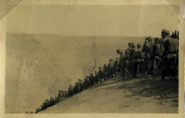 Soldiers marching down hill