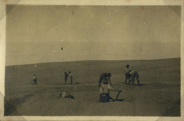 Soldiers digging in desert