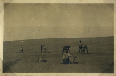 Soldiers digging in desert