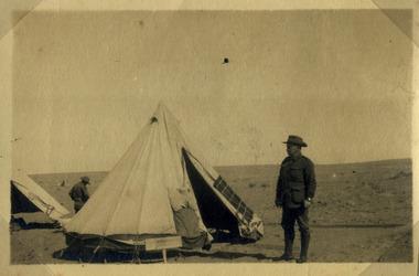 Soldier standing by a tent