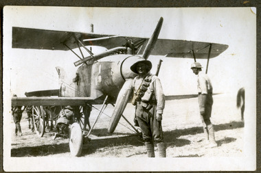 soldier posing infront of aeroplane, robertson thomas098.tif